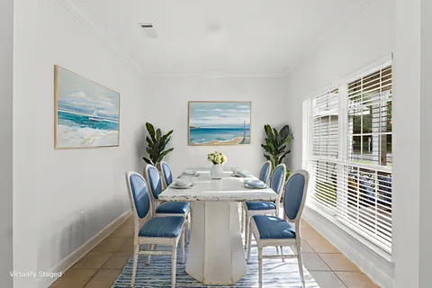 a dining room with furniture and window
