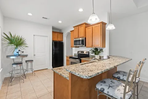a kitchen with kitchen island granite countertop a table and chairs in it