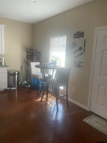 a kitchen with granite countertop a refrigerator stove and sink