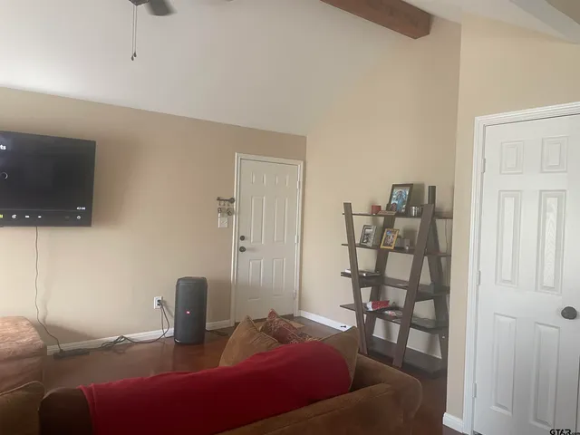 a bedroom with a bed and a night stand