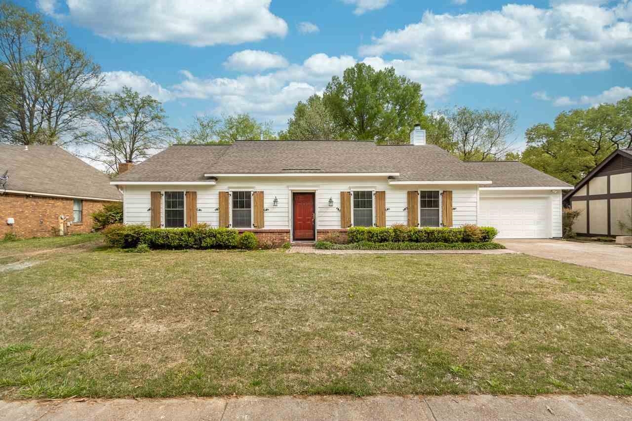 7882 Macon Road Memphis, TN 38018 - Photo 1 of 13 a front view of a house with a yard
