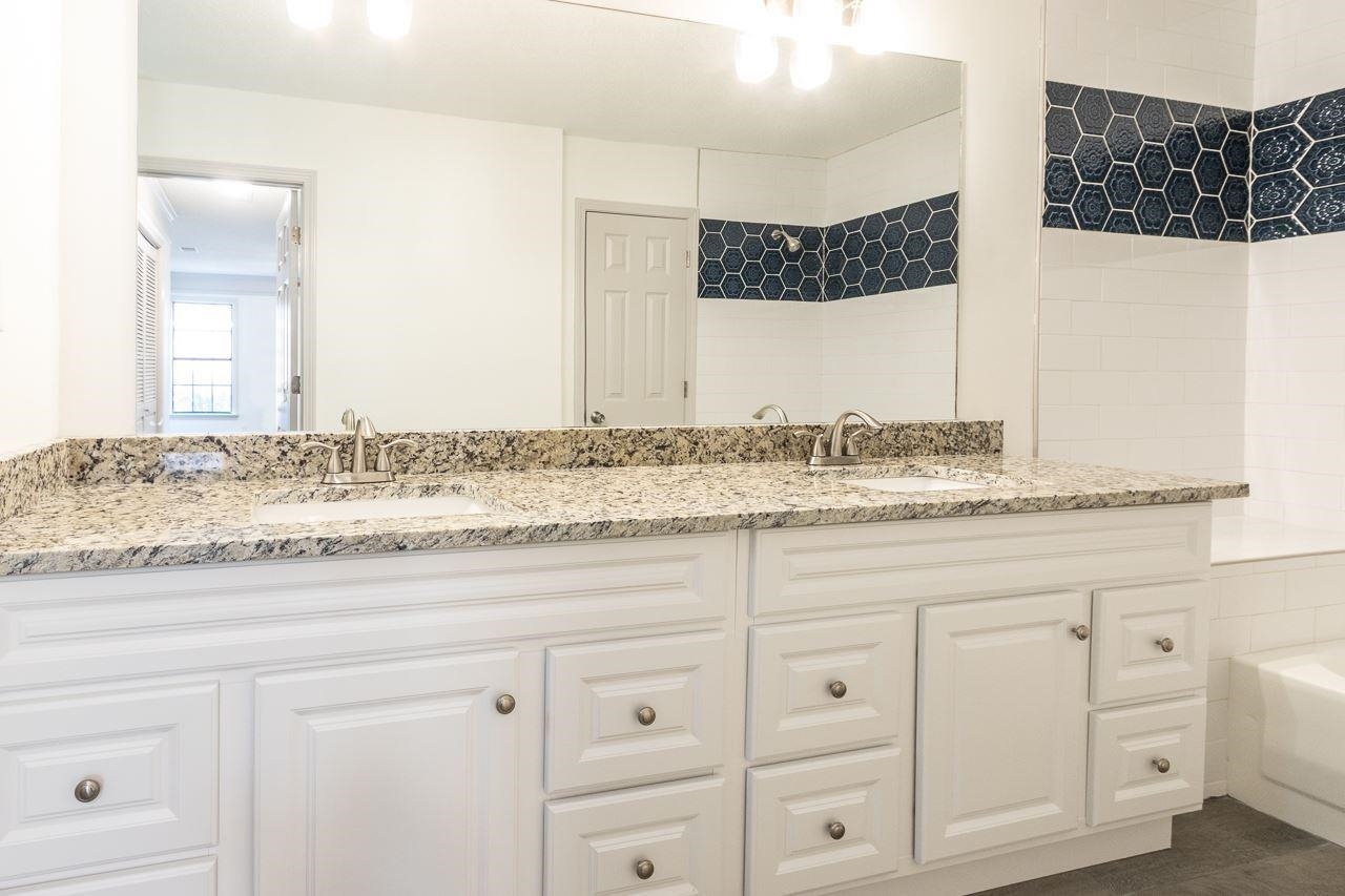 7882 Macon Road Memphis, TN 38018 - Photo 11 of 13 a bathroom with a granite countertop sink and a mirror