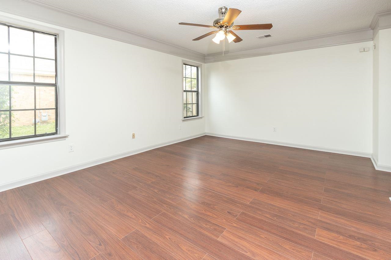 7882 Macon Road Memphis, TN 38018 - Photo 9 of 13 an empty room with wooden floor fan and windows