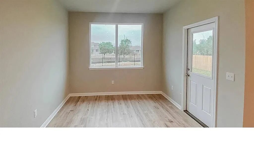 10612 Gonzales Ranger Pass Austin, TX 78754 - Photo 11 of 19 Hardwood floors and an exterior glass door create a versatile dining or study alcove.