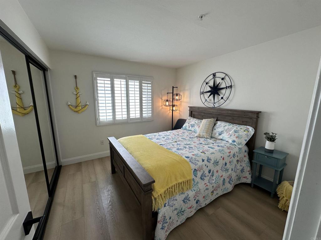 600 The Strand North, Unit 24 Oceanside, CA 92054 - Photo 12 of 19 a bedroom with a bed and a window