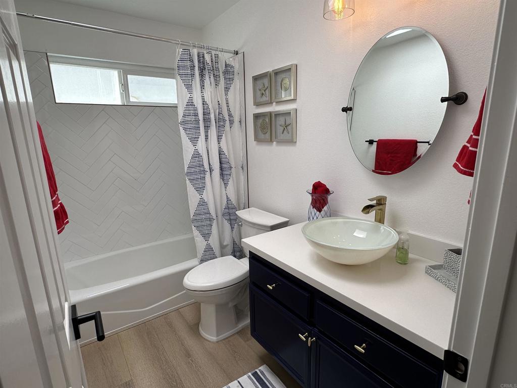 600 The Strand North, Unit 24 Oceanside, CA 92054 - Photo 14 of 19 a bathroom with a sink and a mirror