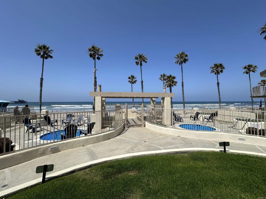 600 The Strand North, Unit 24 Oceanside, CA 92054 - Photo 16 of 19 a view of a swimming pool with a lawn chairs