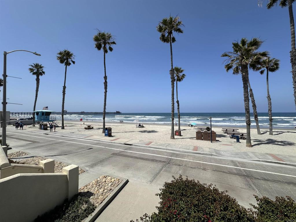 600 The Strand North, Unit 24 Oceanside, CA 92054 - Photo 18 of 19 a view of a swimming pool with a table and chairs