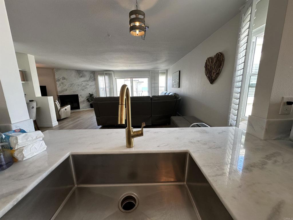 600 The Strand North, Unit 24 Oceanside, CA 92054 - Photo 4 of 19 a living room with furniture and a flat screen tv