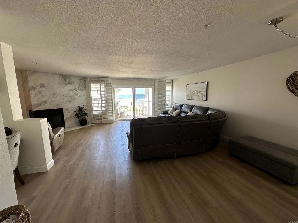 600 The Strand North, Unit 24 Oceanside, CA 92054 - Photo 5 of 19 a living room with furniture and a wooden floor