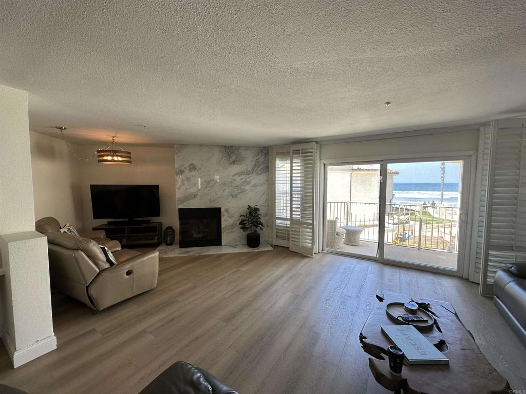 600 The Strand North, Unit 24 Oceanside, CA 92054 - Photo 6 of 19 a living room with furniture and a flat screen tv