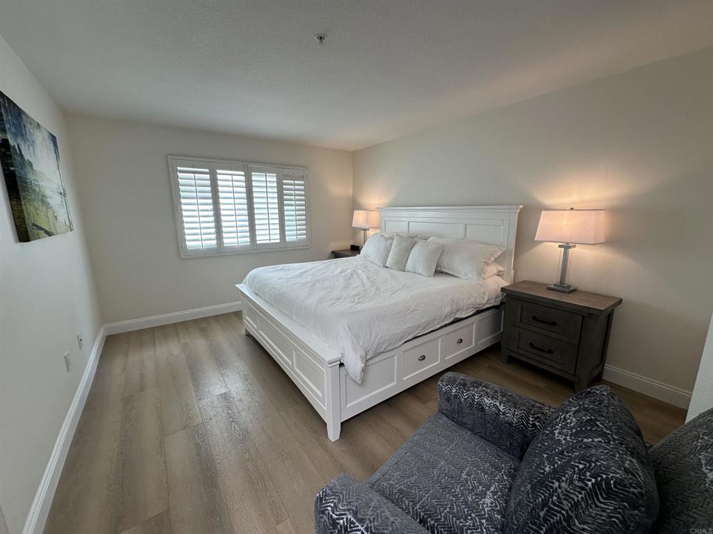 600 The Strand North, Unit 24 Oceanside, CA 92054 - Photo 10 of 19 a living room with a bed furniture and a window