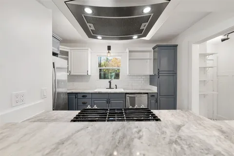 a kitchen with stainless steel appliances a stove and cabinets