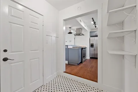 a view of a kitchen with white cabinets