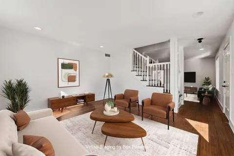 a living room with furniture a rug and a flat screen tv