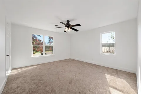 a view of a livingroom with a ceiling fan and window
