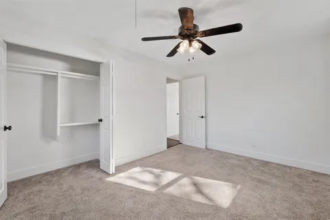 a view of empty room with ceiling fan