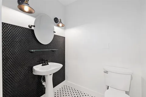 a bathroom with a sink a mirror and a toilet