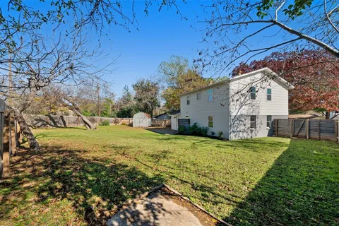 a view of a backyard with large trees