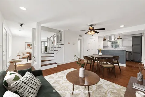 a living room with furniture rug and window