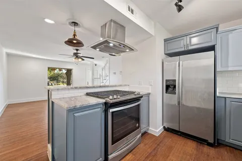 a kitchen with a stove and a refrigerator