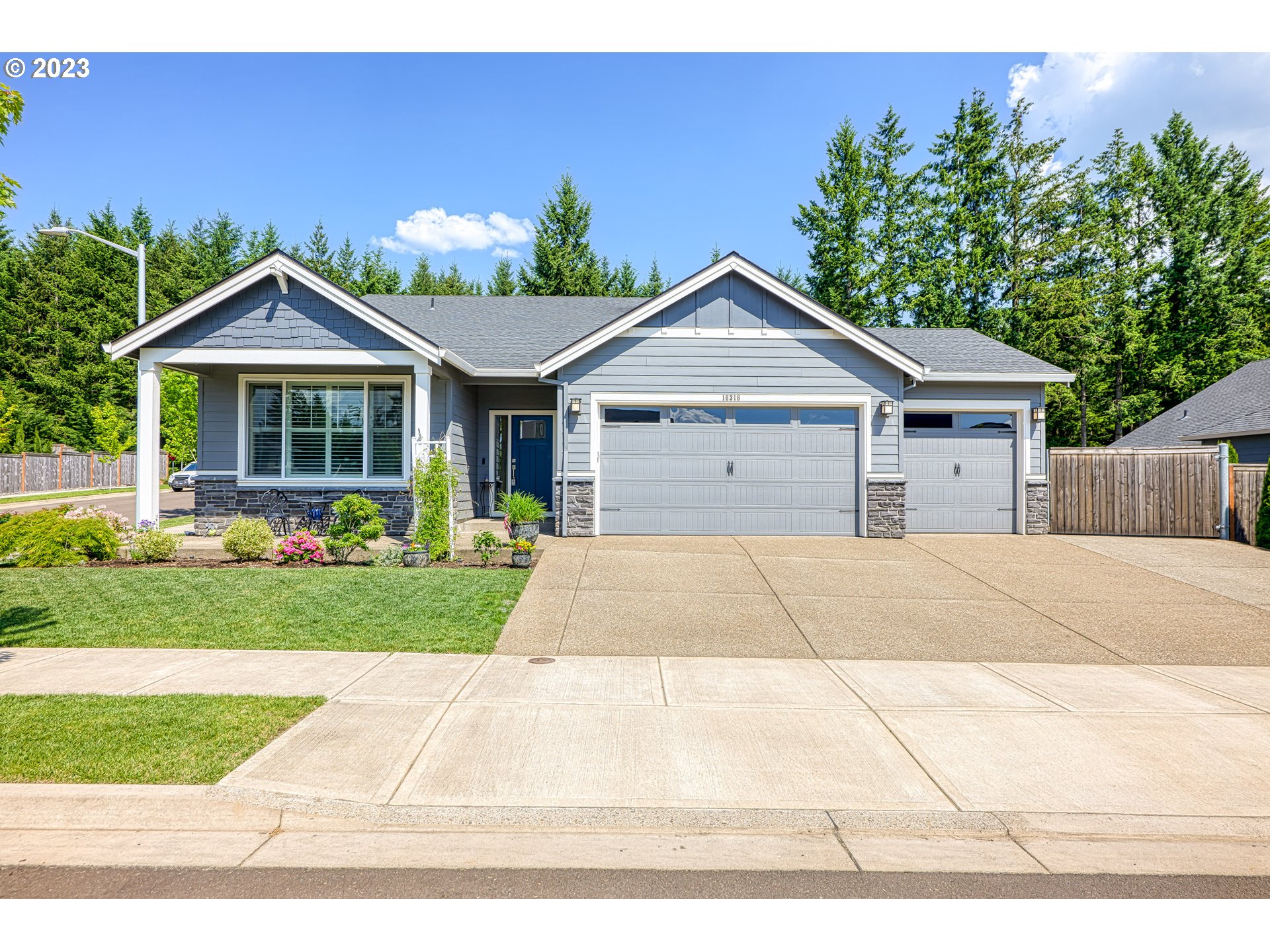 16316 Kitty Hawk Avenue Oregon City, OR 97045 - Photo 1 of 29 a front view of a house with a yard and garage