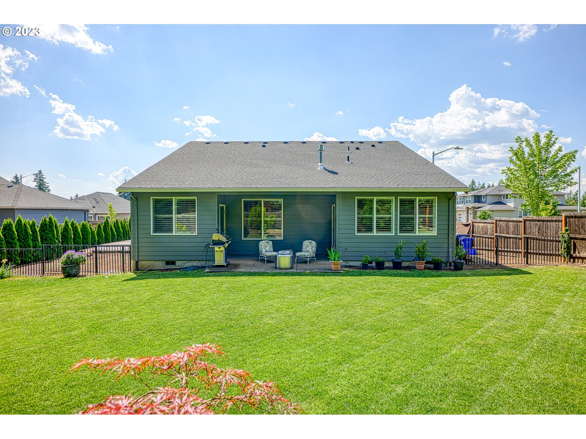 16316 Kitty Hawk Avenue Oregon City, OR 97045 - Photo 26 of 29 a front view of a house with a garden and porch