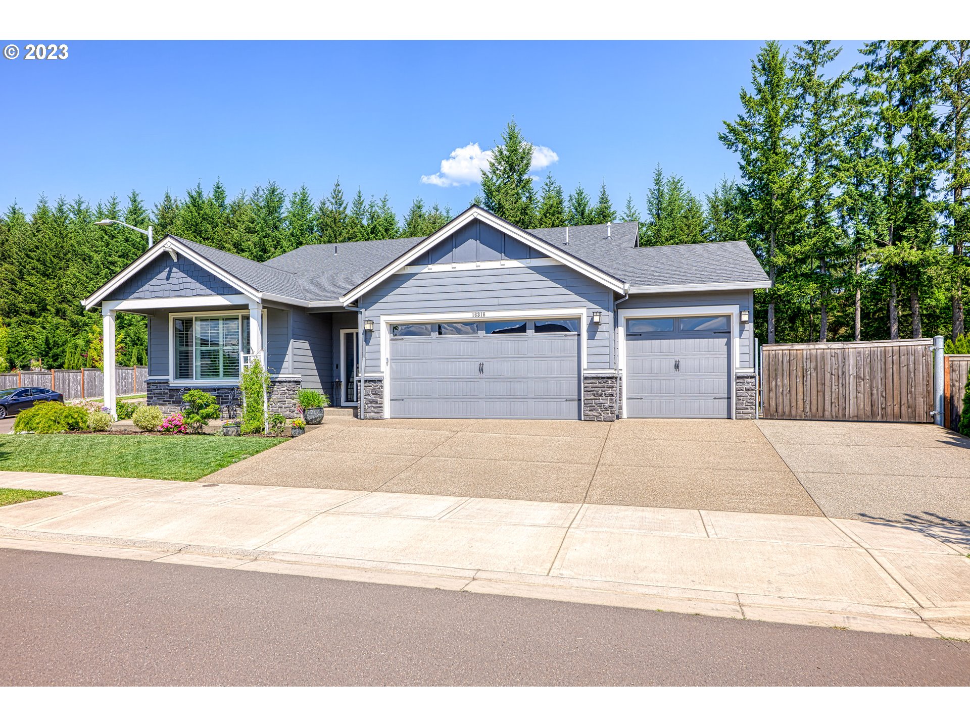 16316 Kitty Hawk Avenue Oregon City, OR 97045 - Photo 3 of 29 a house with a yard and wooden fence
