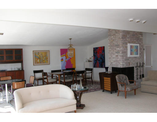 45 Harwich Road Newton, MA 02467 - Photo 3 of 5 a living room with furniture a fireplace and a flat screen tv