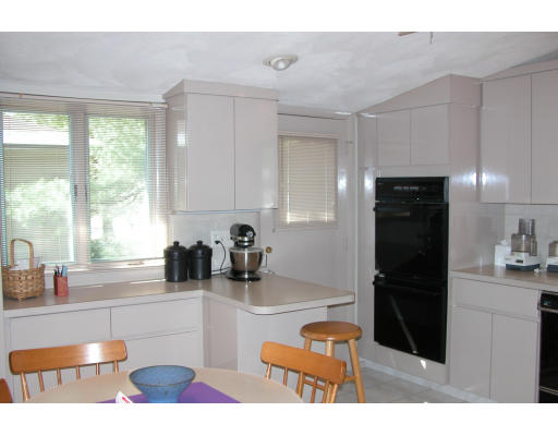 45 Harwich Road Newton, MA 02467 - Photo 4 of 5 a kitchen with stainless steel appliances kitchen island granite countertop a refrigerator and a sink