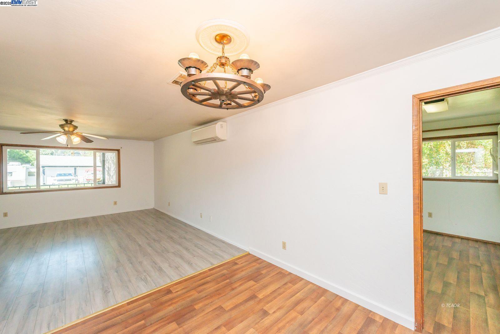 395 Masonic Lane Weaverville, CA 96093 - Photo 11 of 40 an empty room with wooden floor and windows