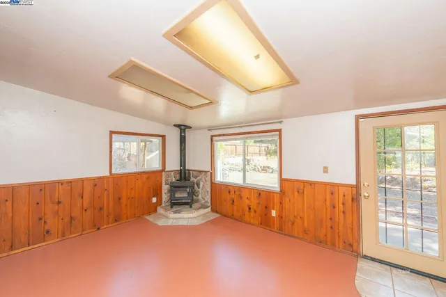 a view of a hallway with wooden floor and a bathroom