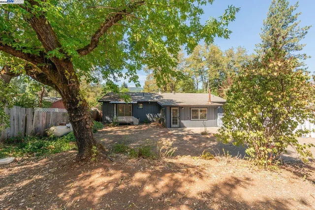 a view of a house with a yard and garage