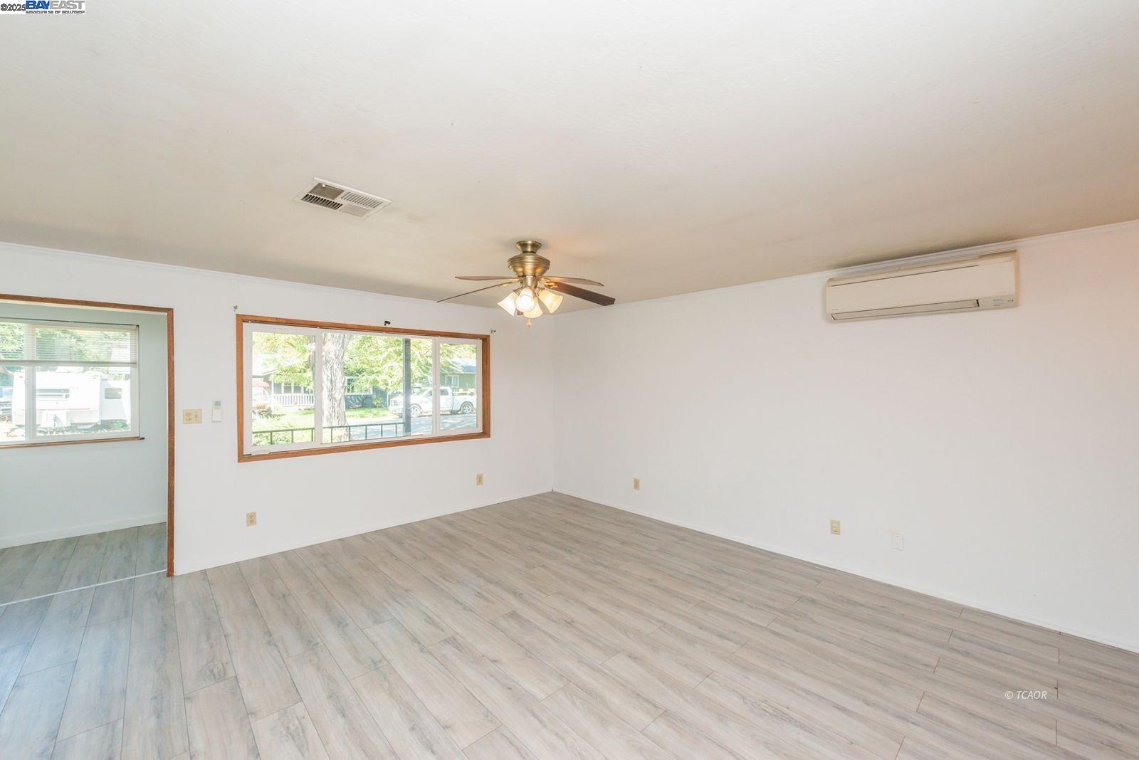 395 Masonic Lane Weaverville, CA 96093 - Photo 9 of 40 an empty room with wooden floor and windows
