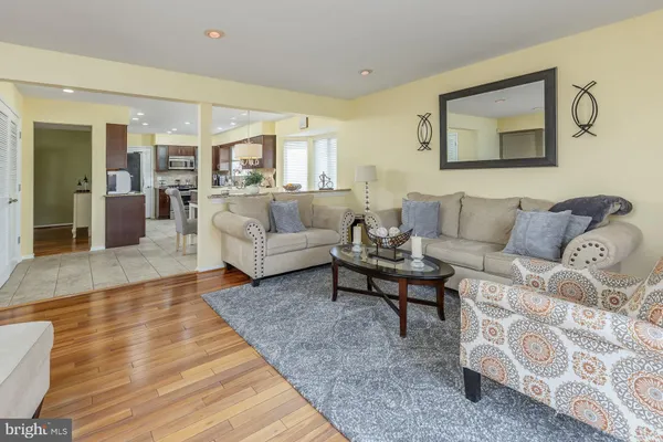 a living room with furniture and a dining table