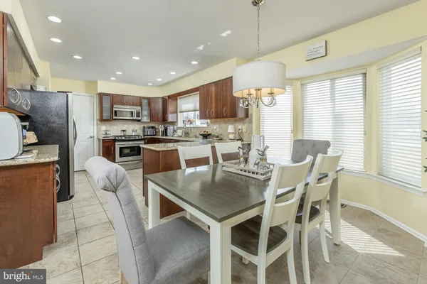 a kitchen with a sink a stove a microwave and cabinets