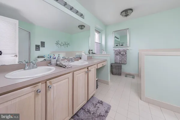 a spacious bathroom with a sink a toilet and a mirror