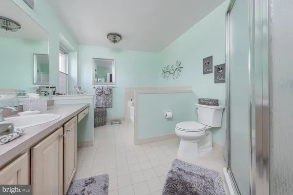 a spacious bedroom with a bed and a window