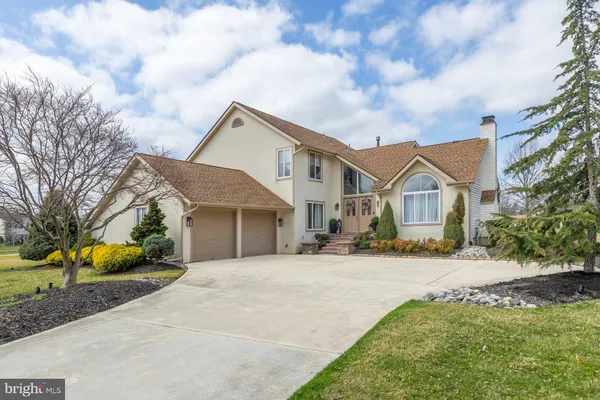 a front view of a house with potted plants