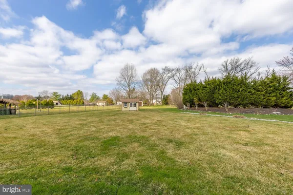 a front view of house with yard having outdoor seating
