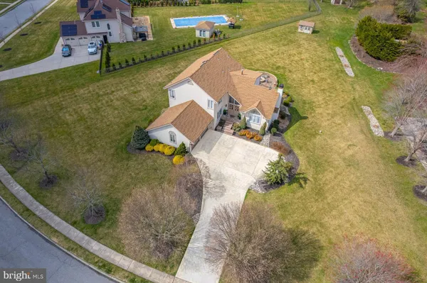 an aerial view of a house with a yard and lake view