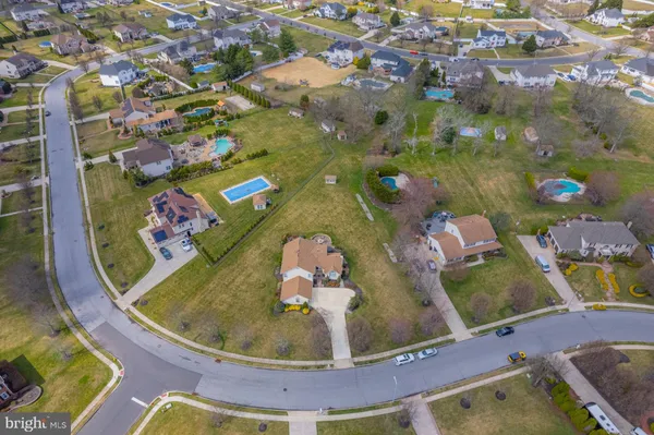 an aerial view of a house with a yard basket ball court and outdoor seating