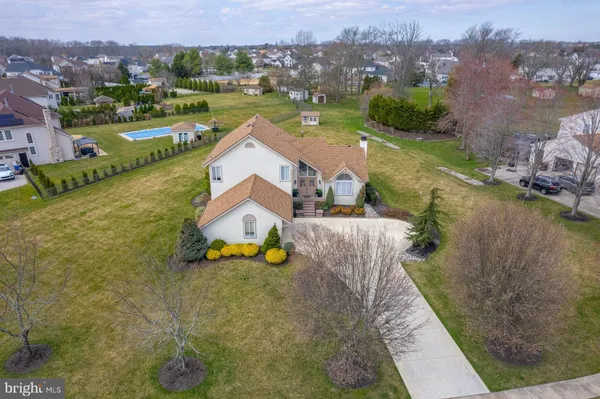 a picture of a hallway with a white wall and a refrigerator