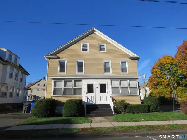 a front view of a house with a yard