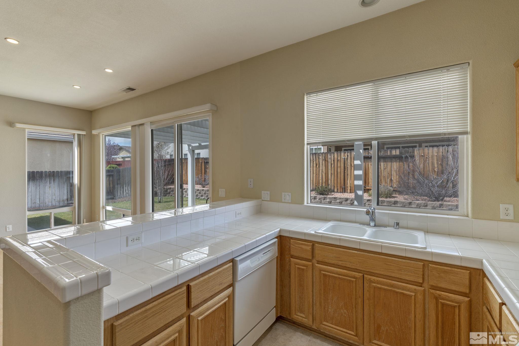 10503 Meeks Bay Court Reno, NV 89521 - Photo 15 of 28 a kitchen with granite countertop sink and window