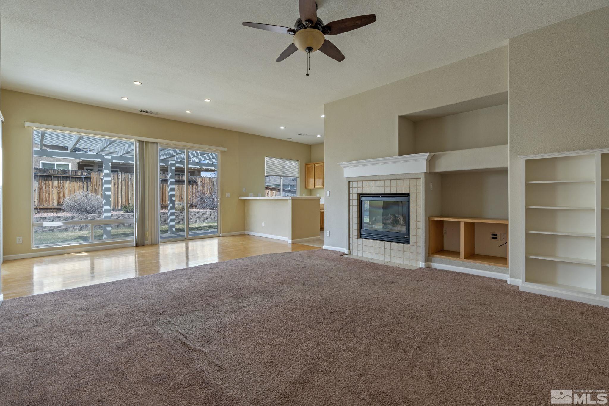 10503 Meeks Bay Court Reno, NV 89521 - Photo 5 of 28 a view of an empty room with a fireplace and a window