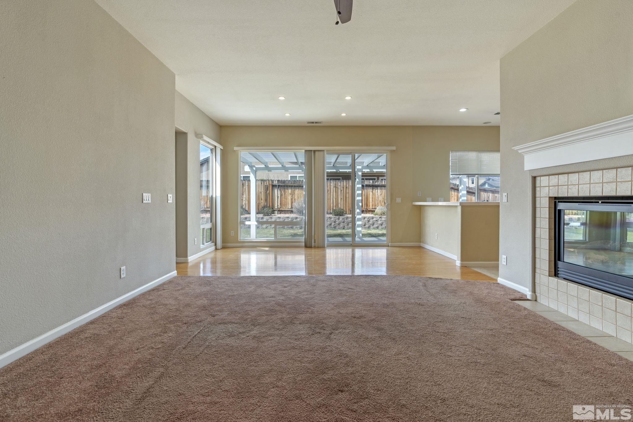 10503 Meeks Bay Court Reno, NV 89521 - Photo 6 of 28 a view of an empty room with a fireplace and a window