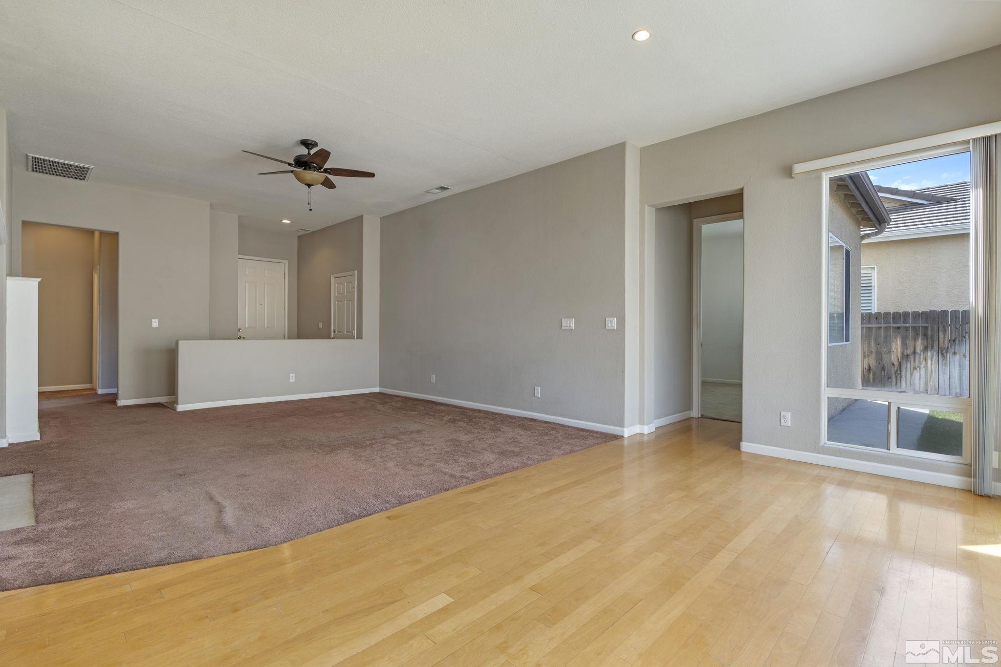 10503 Meeks Bay Court Reno, NV 89521 - Photo 8 of 28 a view of an empty room with a chandelier fan and windows