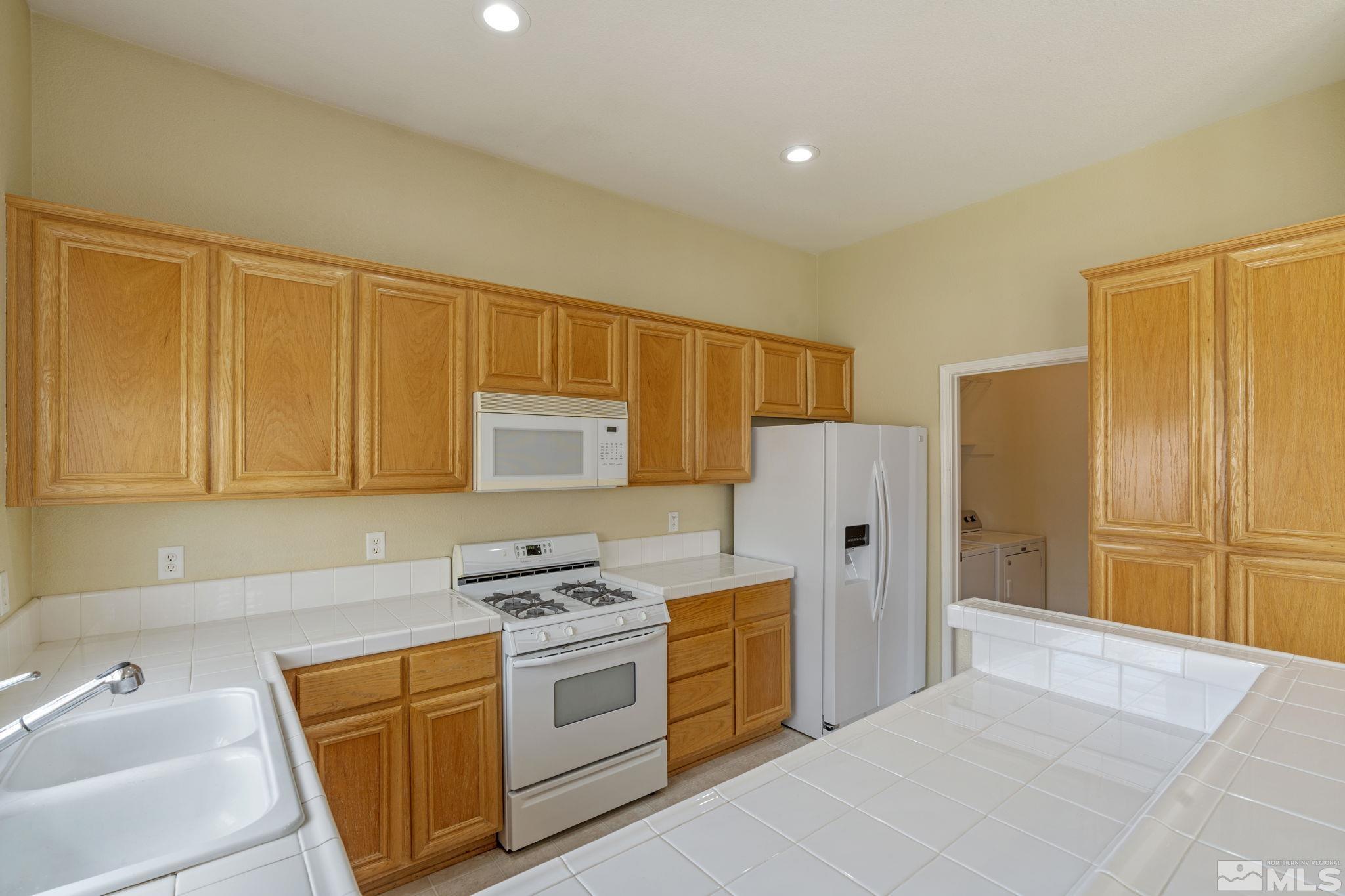 10503 Meeks Bay Court Reno, NV 89521 - Photo 10 of 28 a kitchen with stainless steel appliances granite countertop a refrigerator and a sink