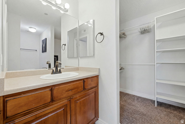 116 East Resaca Drive, Unit F6 Sandy, UT 84070 - Photo 20 of 32 Vanity with a neutral countertop, undermount sink, and black-finish faucet